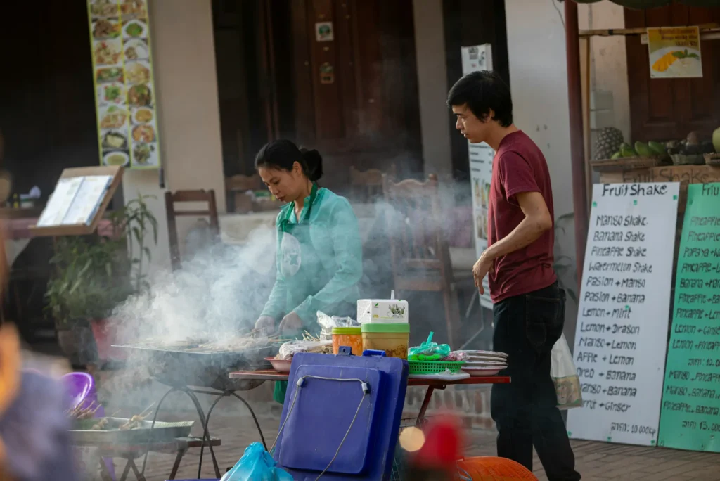Laos Outdoor market vendor selling their goods