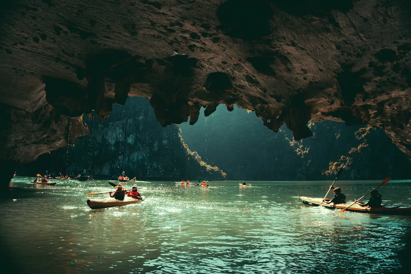 Limestone karsts and a kayaker on Ha Long Bay, Vietnam